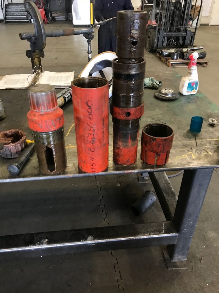 Downhole tubulars, crossover subs, and intervention tools on workshop bench